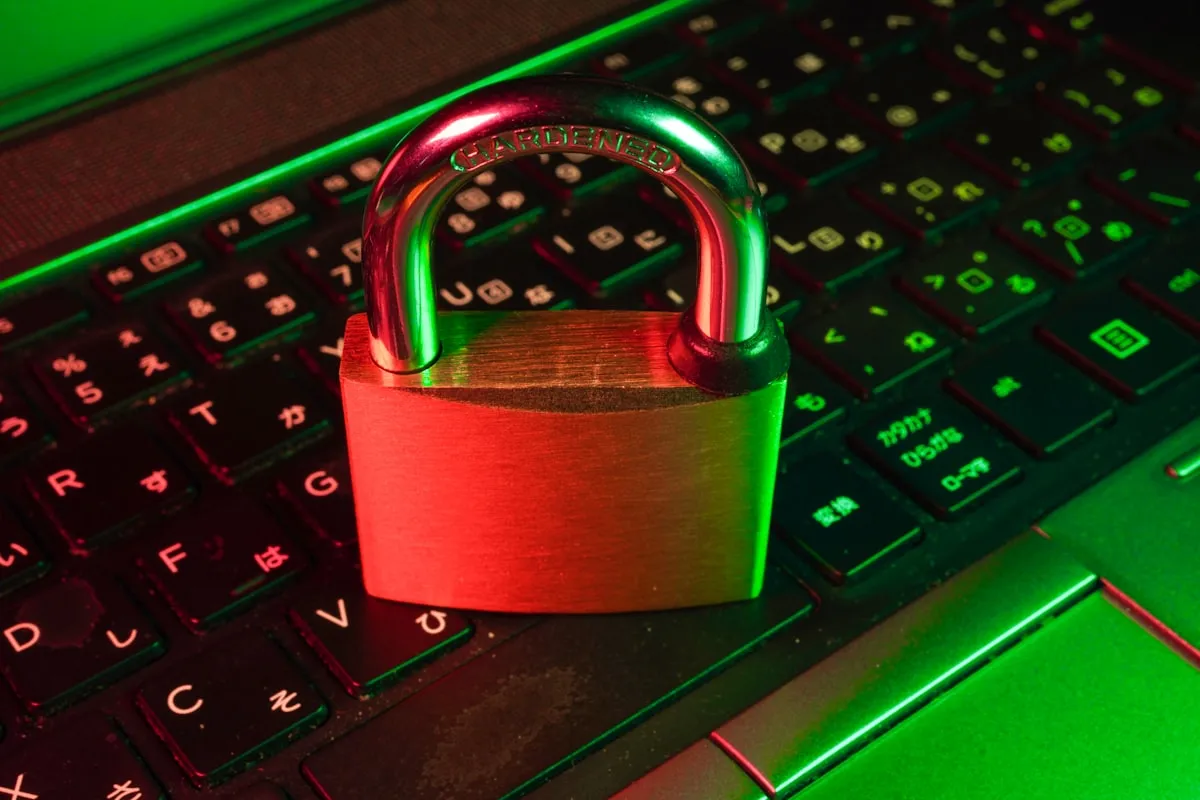 Red padlock resting on a black computer keyboard, symbolizing digital security and encryption