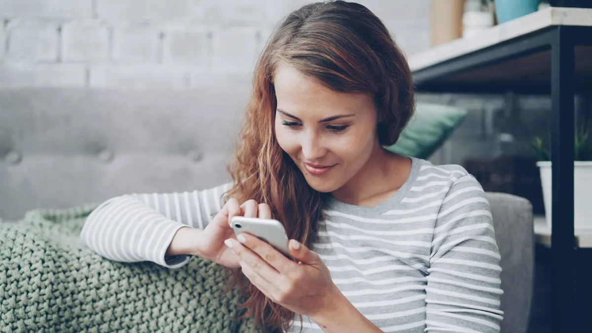 Young woman smiling while looking at her phone, checking a social or dating app
